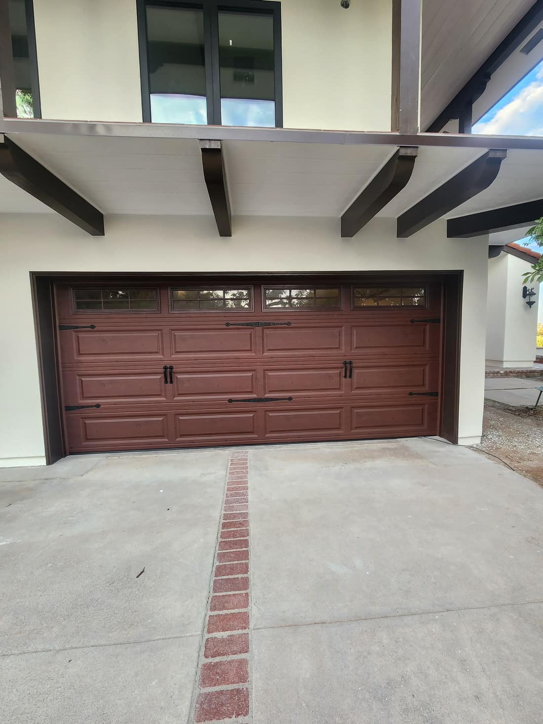 Dark woodgrain long-panel garage door with windows
