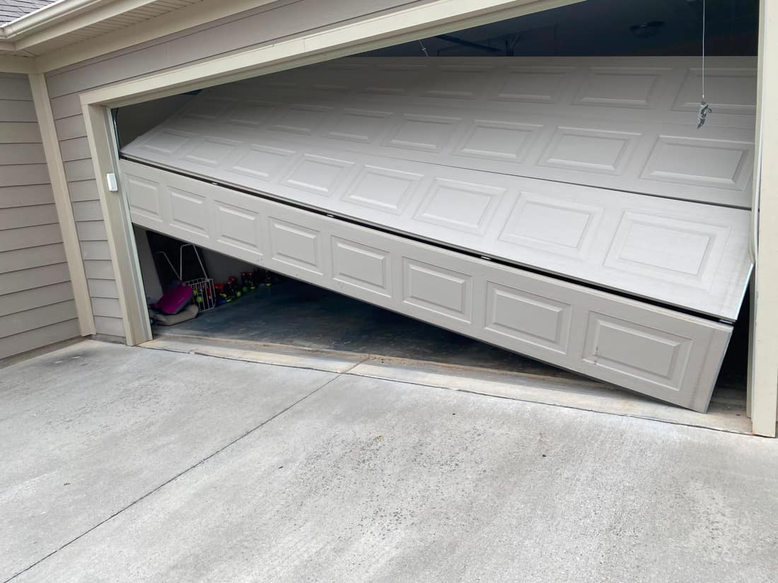 Garage door off its tracks before repair
