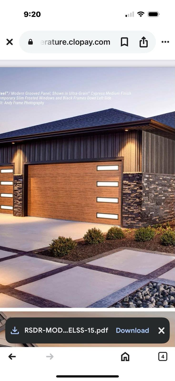 Modern woodgrain garage door with vertical glass accents
