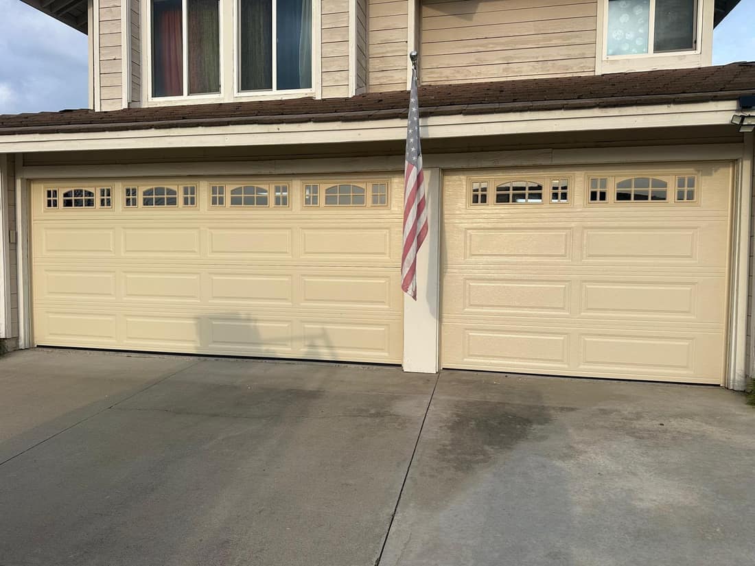 Cream carriage-style three-car garage doors