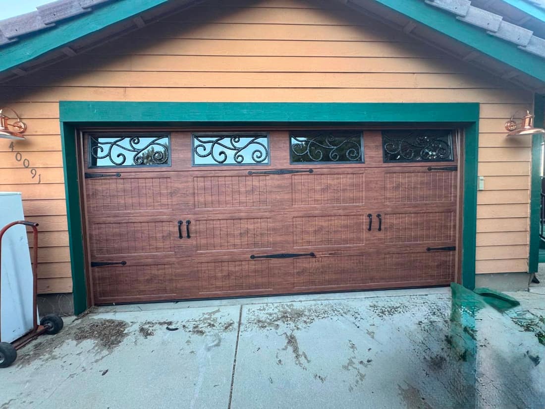 Woodgrain carriage-house garage door with decorative windows